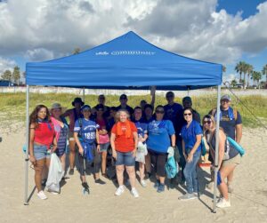 Volunteers from FirstService Residential pose for a photo on Galveston Beach
